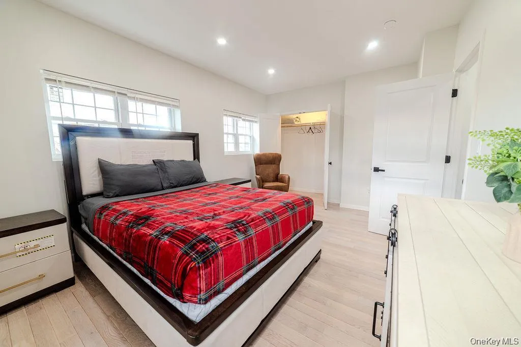Bedroom featuring light wood-style floors, recessed lighting, and a closet Bedroom featuring light wood-style floors, recessed lighting, and a closet