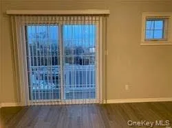 Spare room with wood finished floors and baseboards Spare room with wood finished floors and baseboards