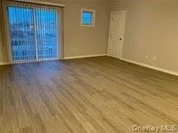 Spare room with wood finished floors and baseboards Spare room with wood finished floors and baseboards