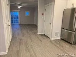 Hallway featuring light wood-type flooring and baseboards Hallway featuring light wood-type flooring and baseboards