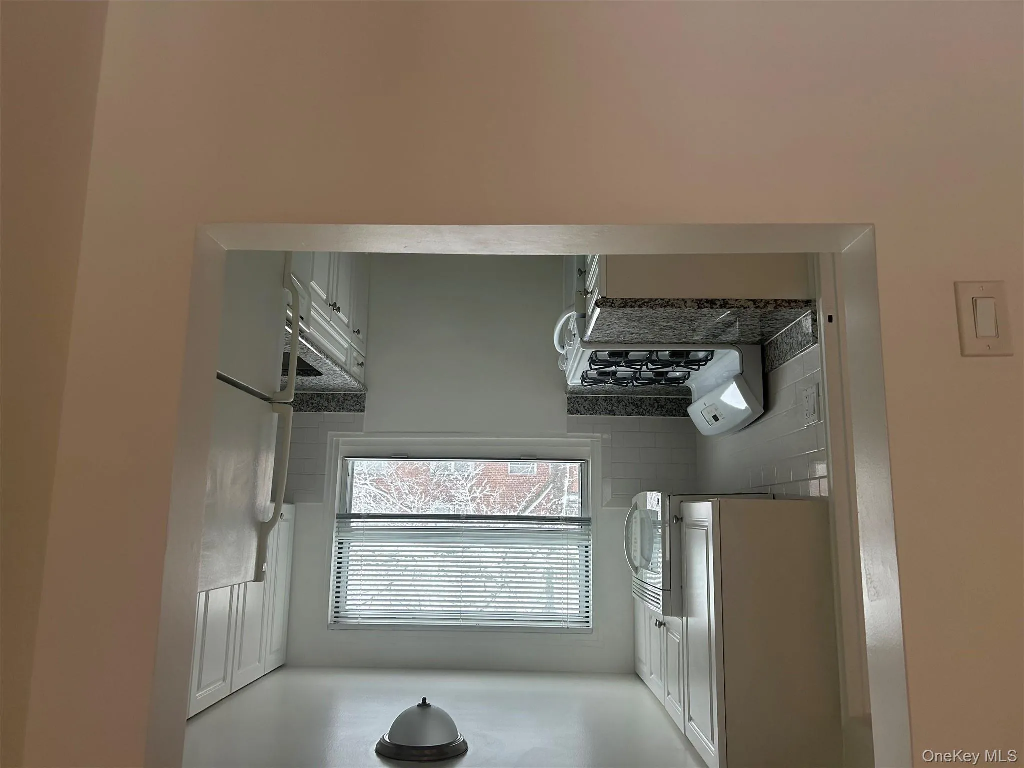 Kitchen featuring white cabinetry, white stove, refrigerator, and tasteful backsplash Kitchen featuring white cabinetry, white stove, refrigerator, and tasteful backsplash