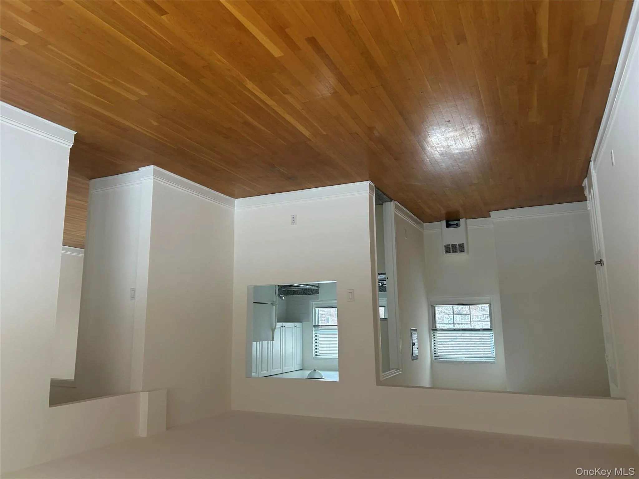 Unfurnished living room with hardwood / wood-style floors and baseboards Unfurnished living room with hardwood / wood-style floors and baseboards