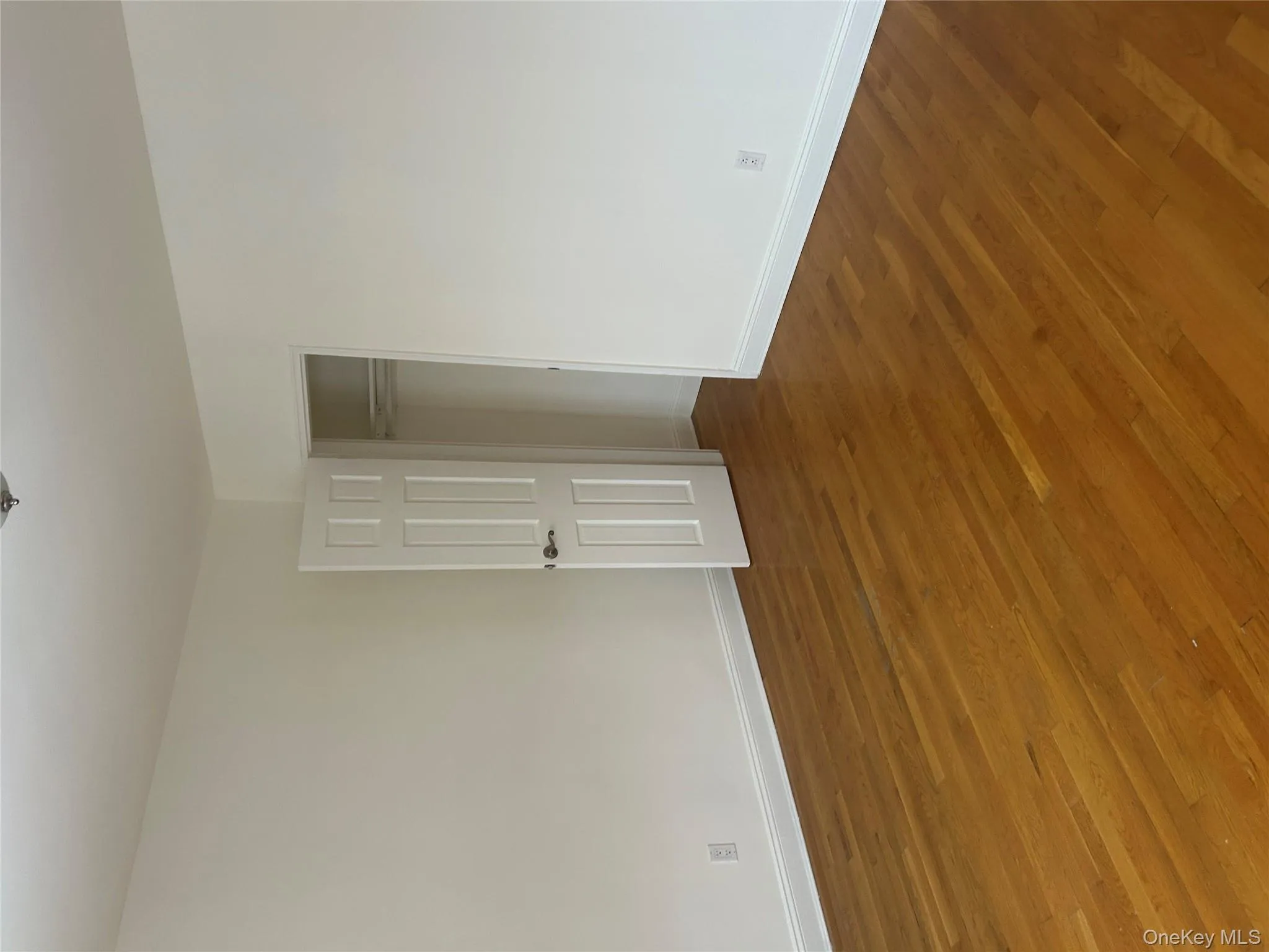 Unfurnished bedroom featuring dark wood-type flooring and a closet Unfurnished bedroom featuring dark wood-type flooring and a closet
