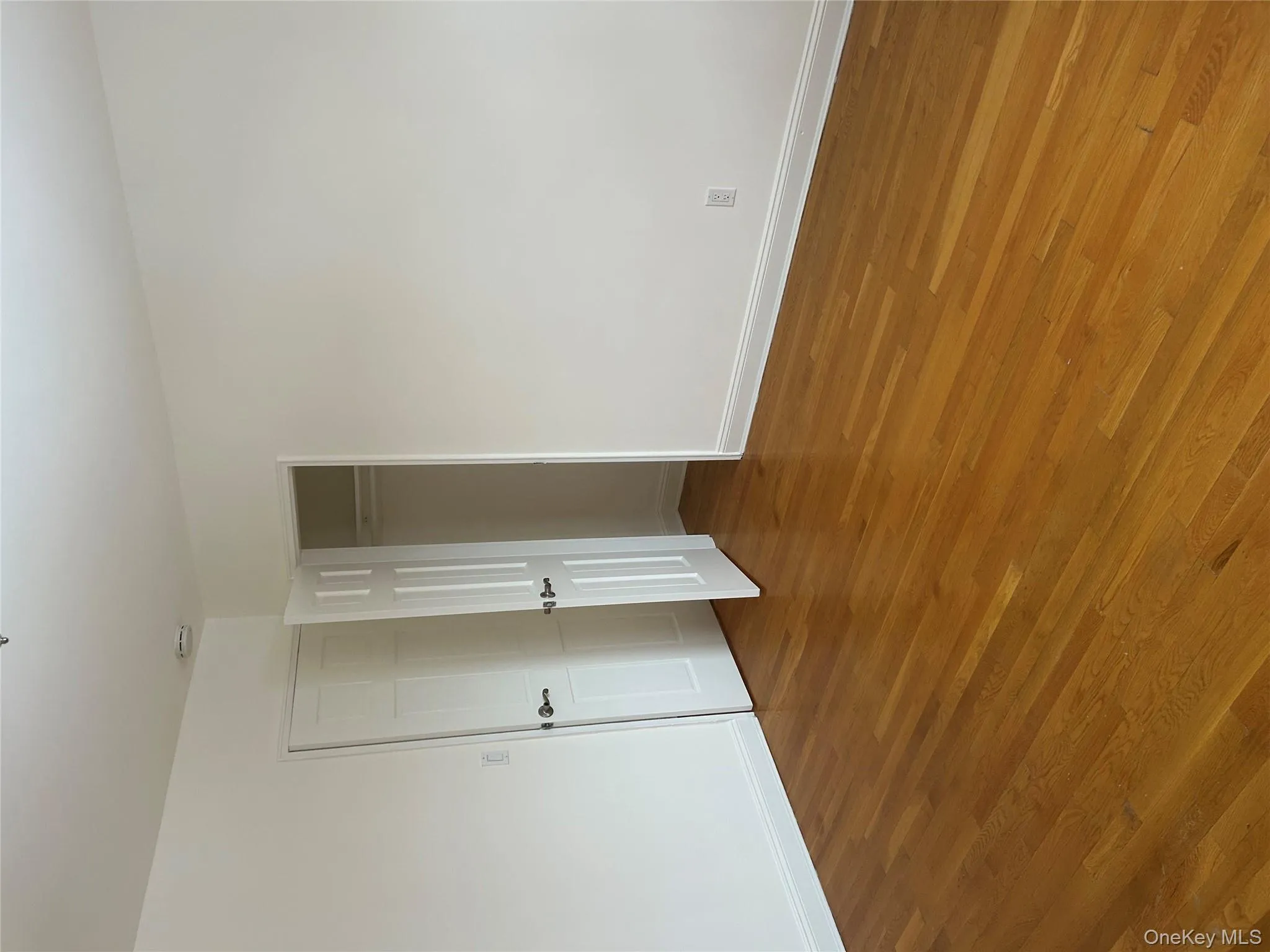 Unfurnished bedroom with wood finished floors and a closet Unfurnished bedroom with wood finished floors and a closet