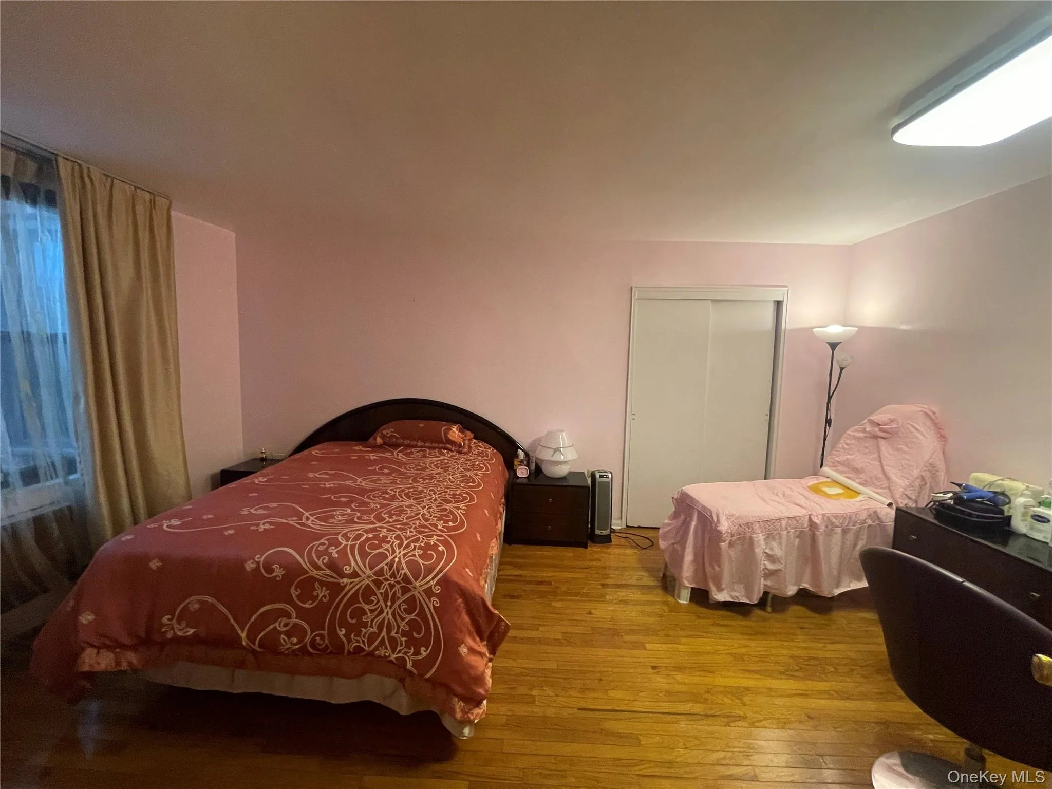 Bedroom featuring a closet and wood-type flooring Bedroom featuring a closet and wood-type flooring