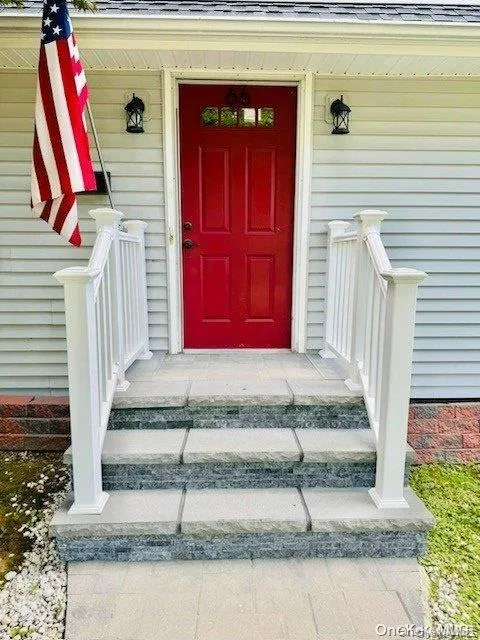 Doorway to property with a shingled roof Doorway to property with a shingled roof