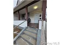 Property entrance featuring a porch Property entrance featuring a porch