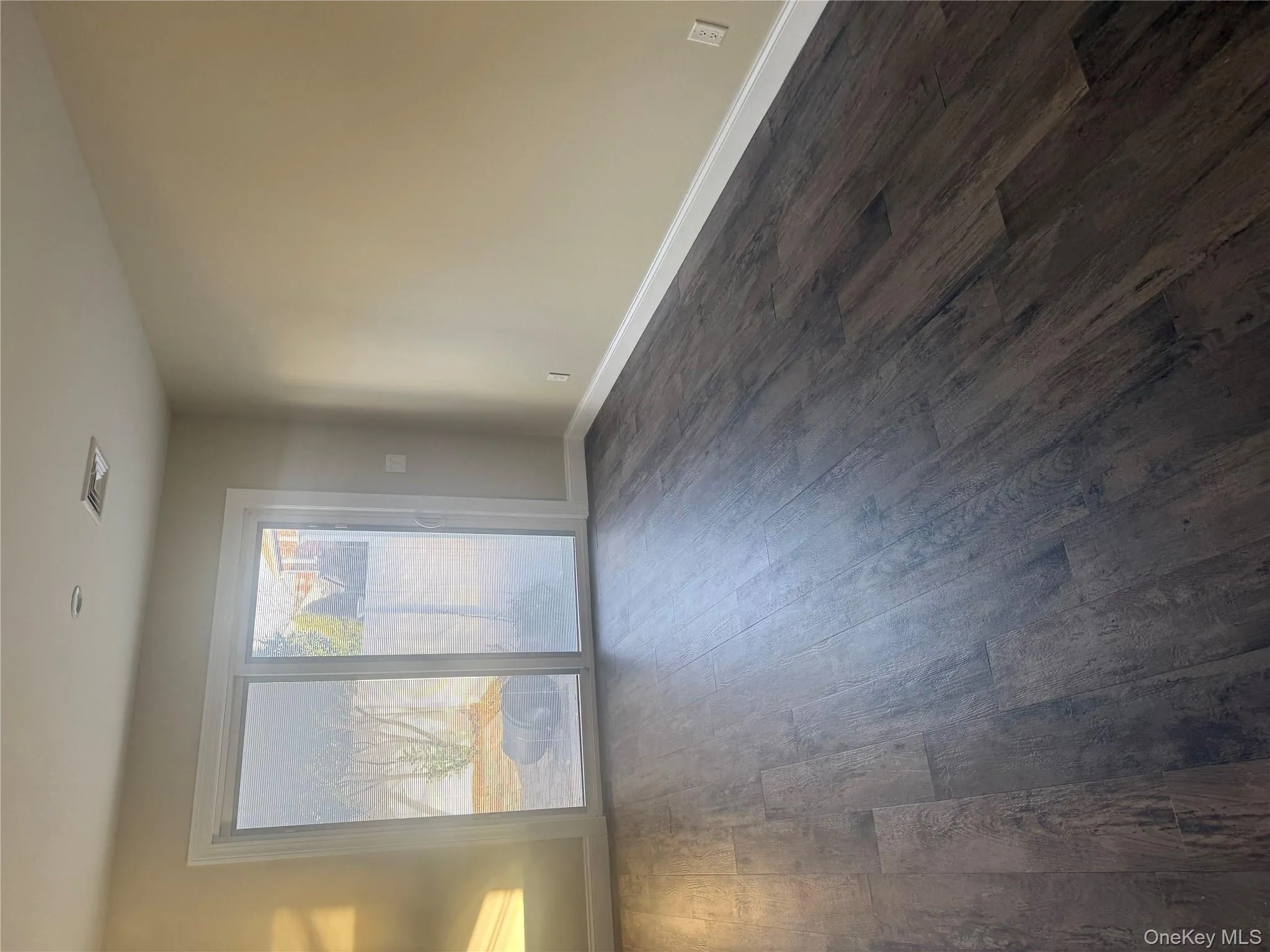 Unfurnished room featuring dark wood-style floors Unfurnished room featuring dark wood-style floors