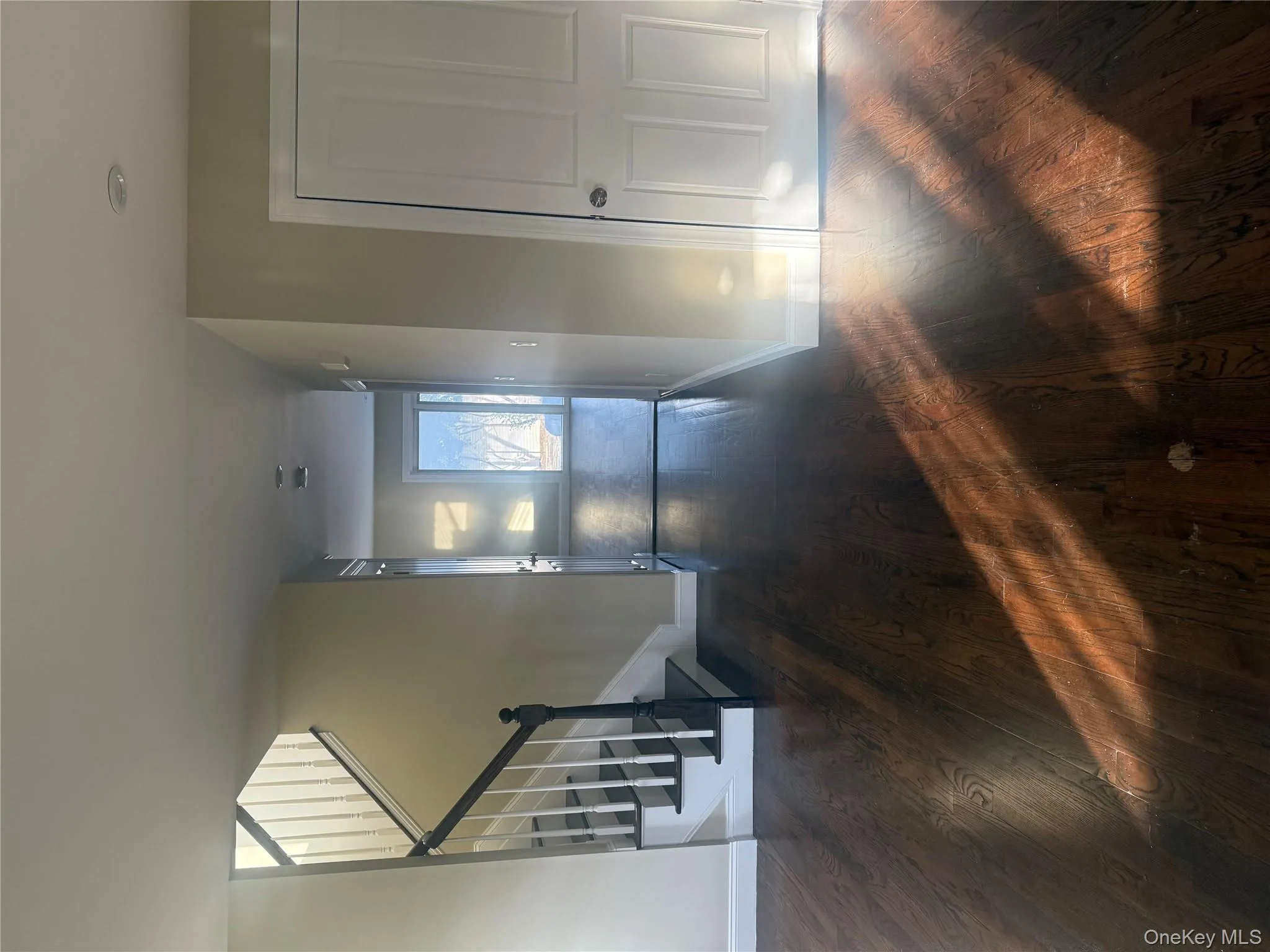 Staircase featuring hardwood / wood-style floors Staircase featuring hardwood / wood-style floors