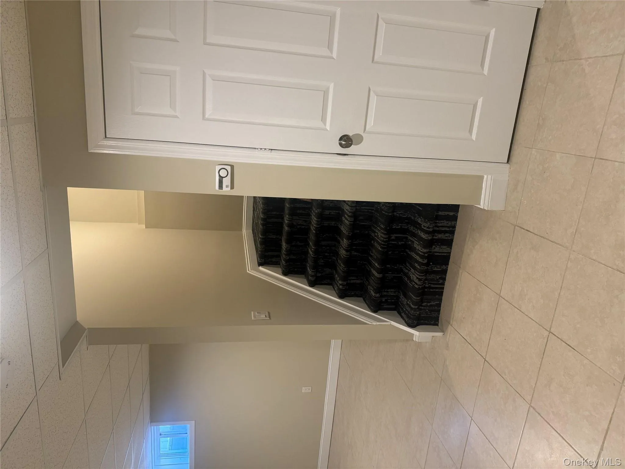 Stairs with tile patterned flooring and a paneled ceiling Stairs with tile patterned flooring and a paneled ceiling