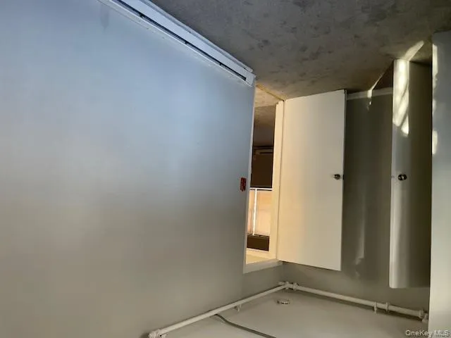 Carpeted spare room featuring a baseboard radiator Carpeted spare room featuring a baseboard radiator