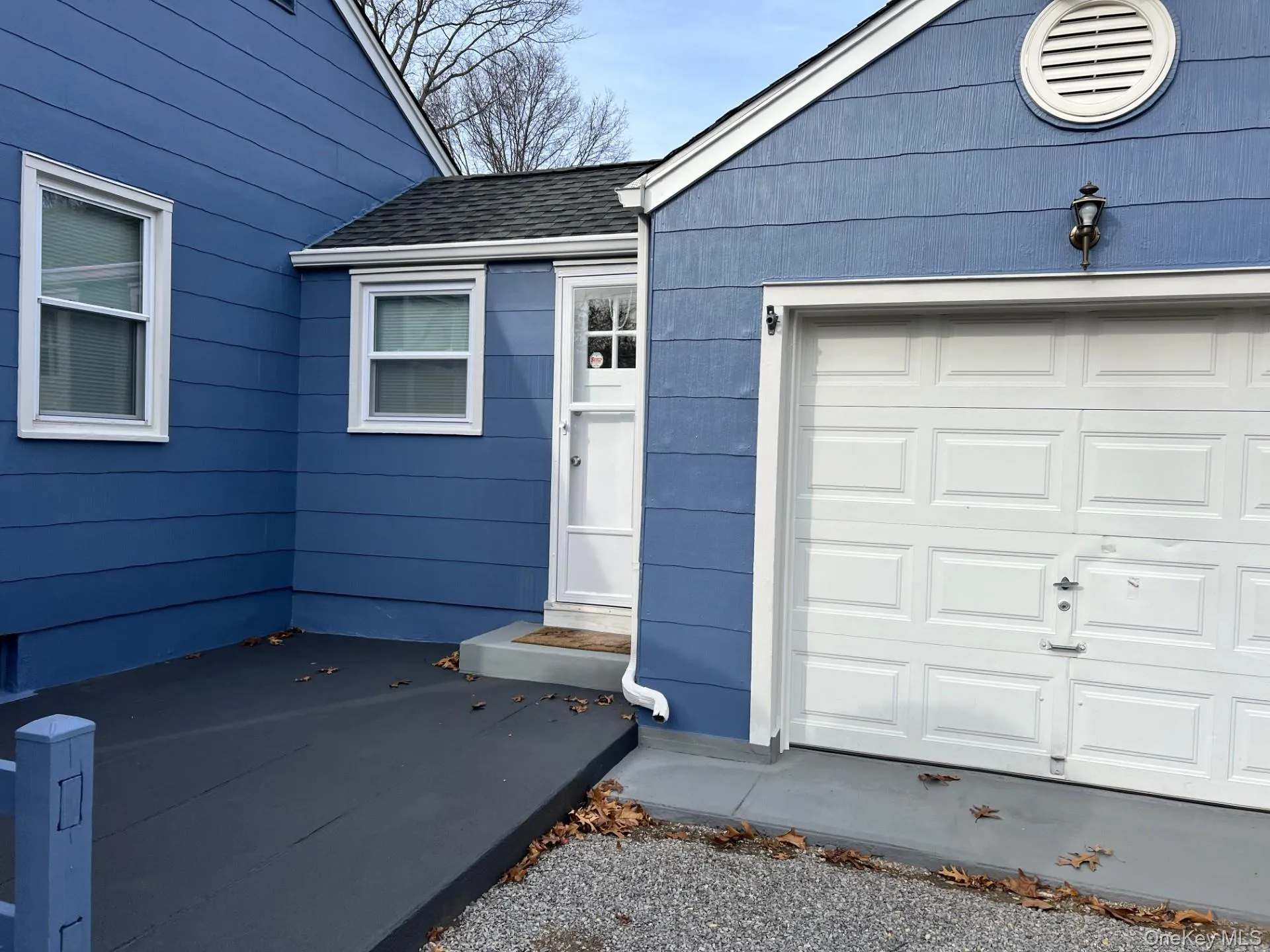 Doorway to property featuring a shingled roof Doorway to property featuring a shingled roof