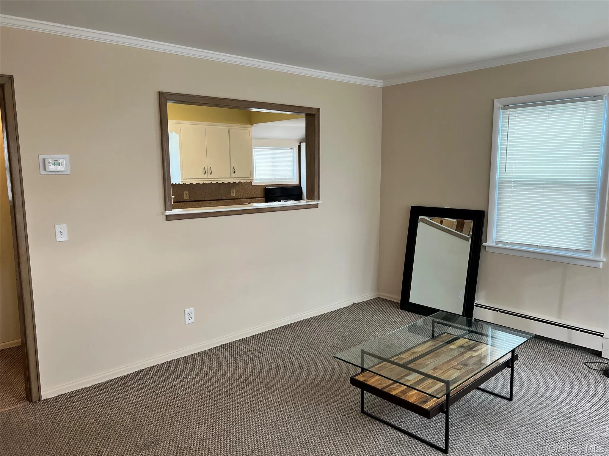 Living room with service window to kitchen Living room with service window to kitchen
