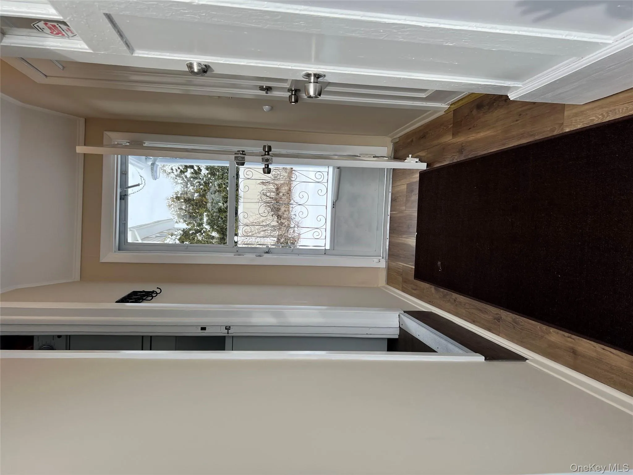 Entryway featuring wood finished floors and ornamental molding Entryway featuring wood finished floors and ornamental molding