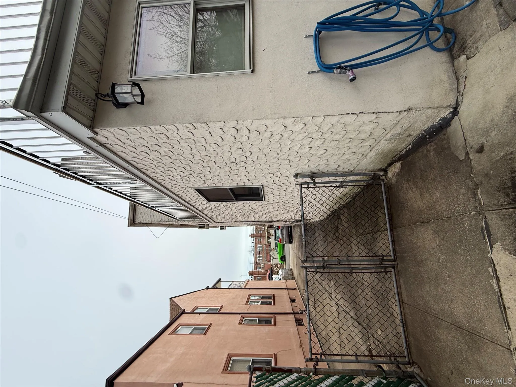 View of home's exterior featuring a gate and stucco siding View of home's exterior featuring a gate and stucco siding