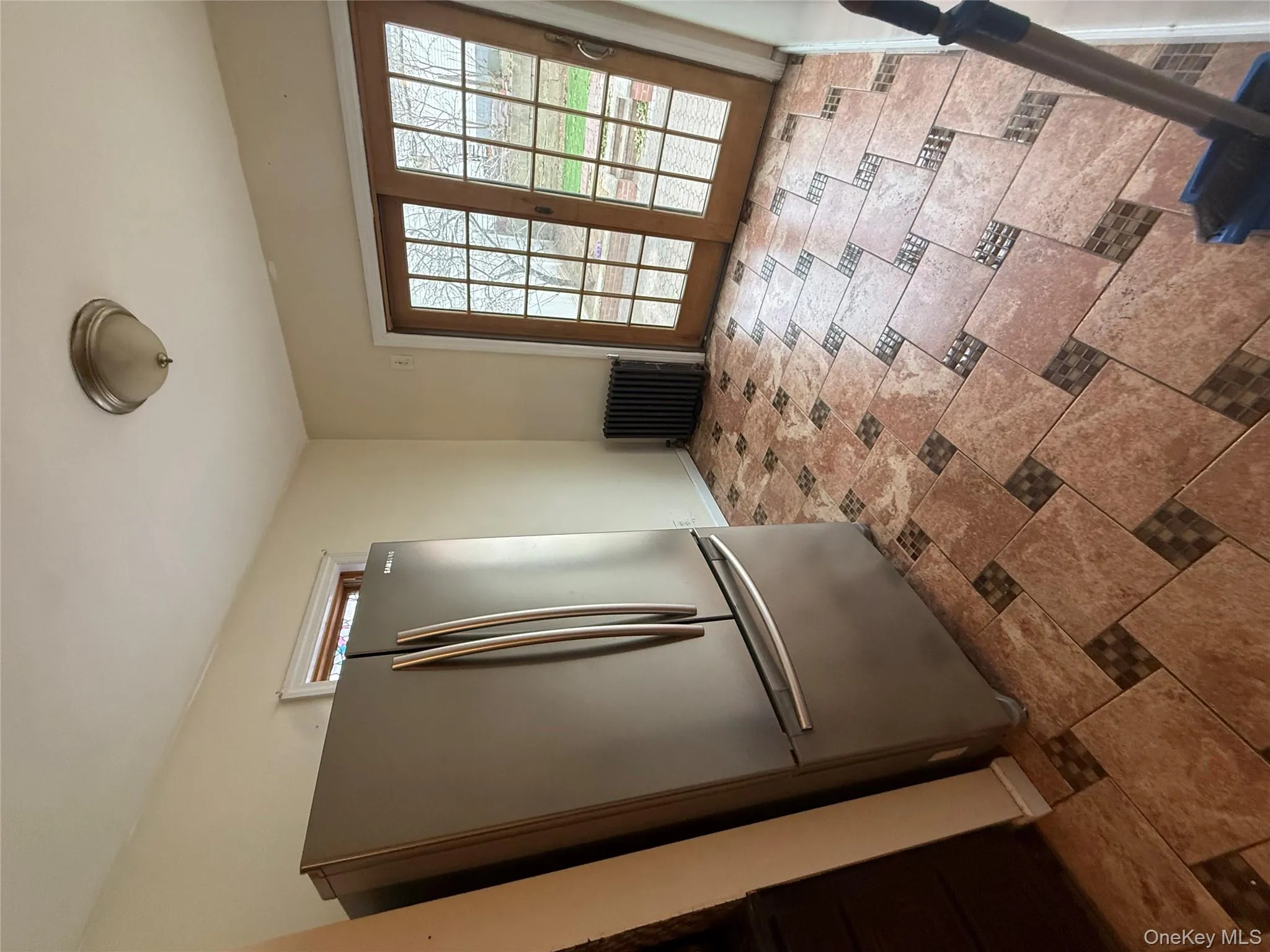 Kitchen with freestanding refrigerator and radiator Kitchen with freestanding refrigerator and radiator