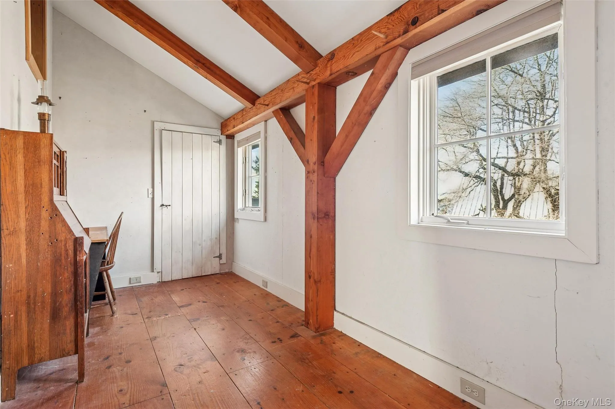 Bonus room with wood-type flooring and baseboards Bonus room with wood-type flooring and baseboards
