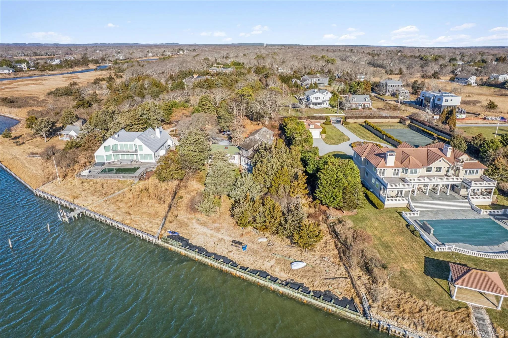 Aerial perspective of suburban area featuring a nearby body of water Aerial perspective of suburban area featuring a nearby body of water