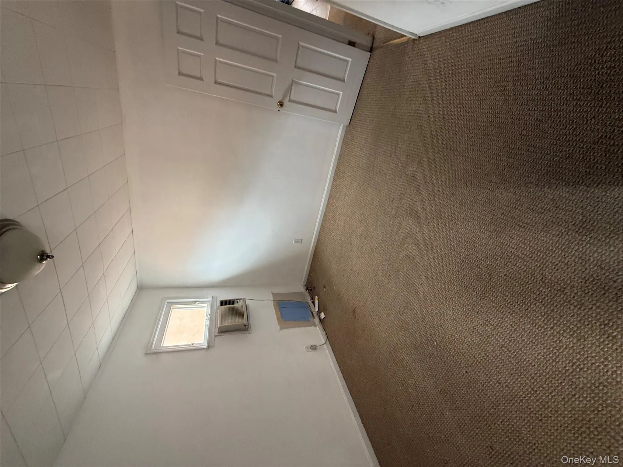 Carpeted spare room featuring baseboards Carpeted spare room featuring baseboards