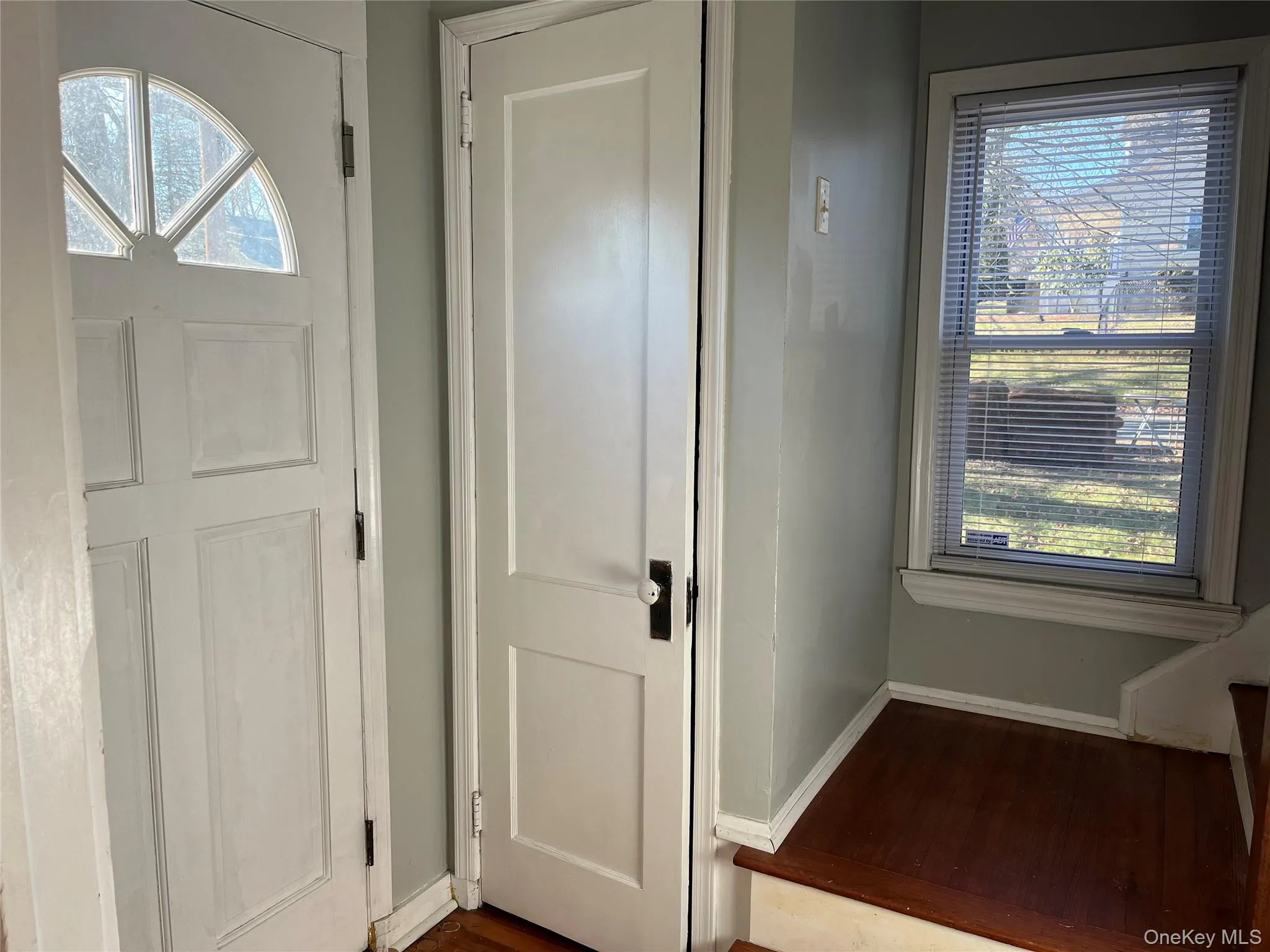 Doorway featuring baseboards and wood finished floors Doorway featuring baseboards and wood finished floors