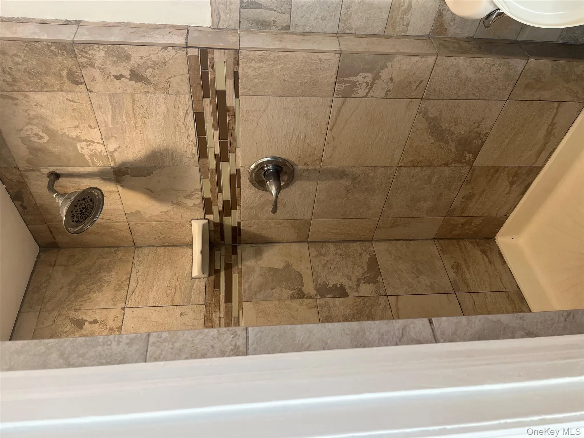 Full bath featuring a shower stall Full bath featuring a shower stall