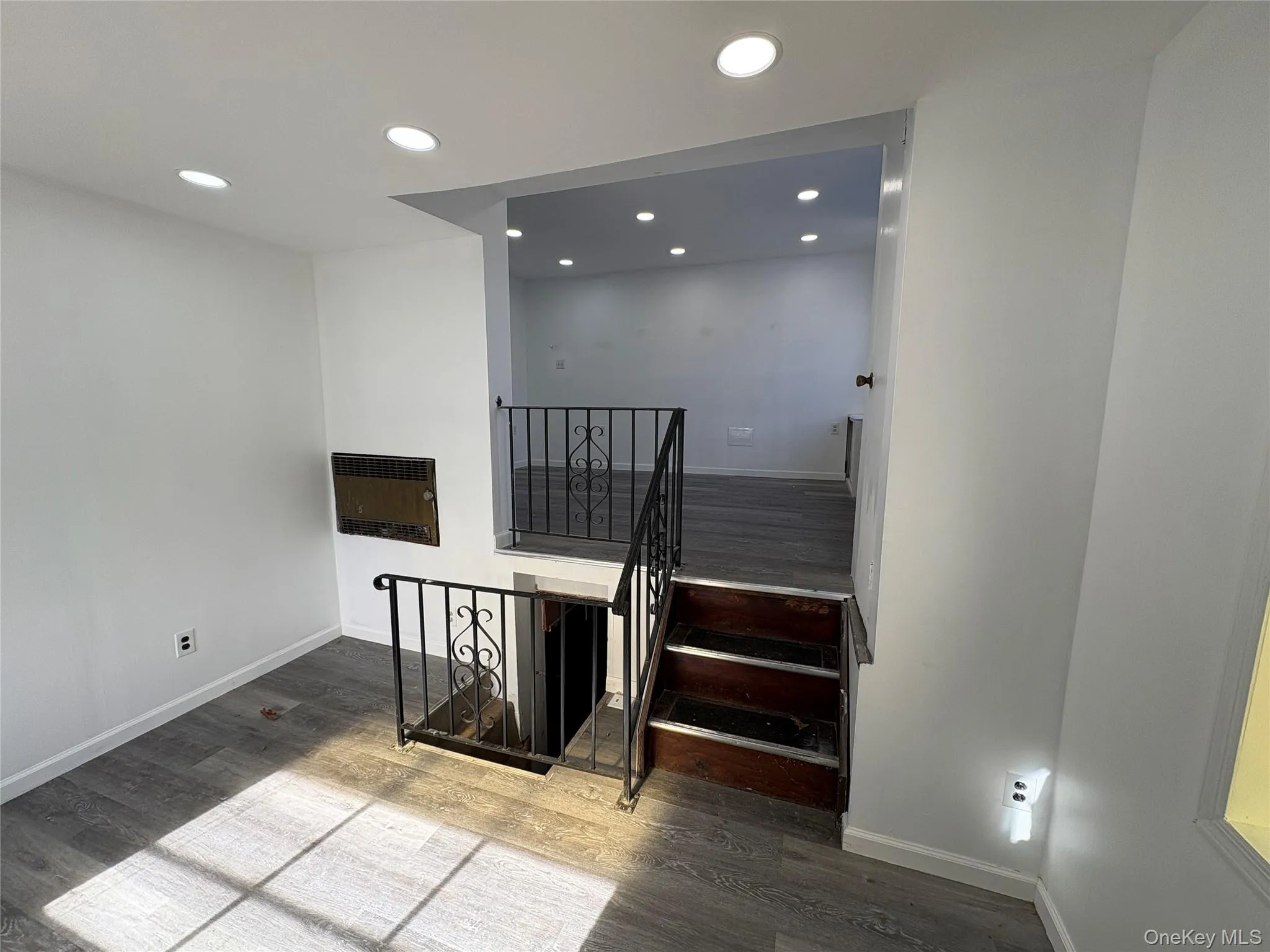 Stairs with heating unit, recessed lighting, and wood finished floors Stairs with heating unit, recessed lighting, and wood finished floors