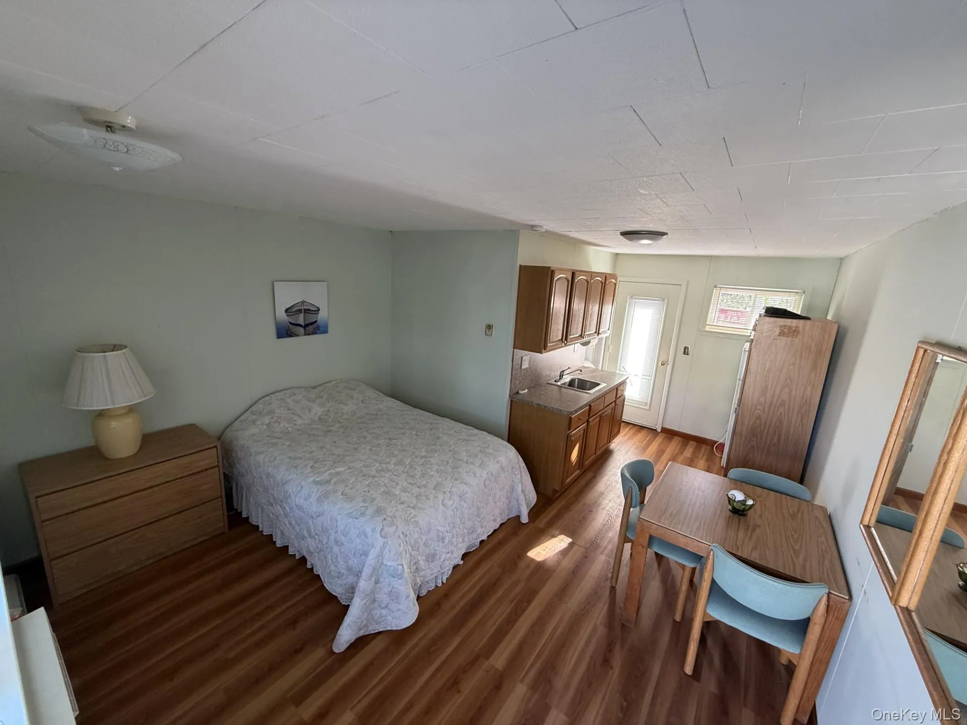 Bedroom with wood finished floors and a sink Bedroom with wood finished floors and a sink