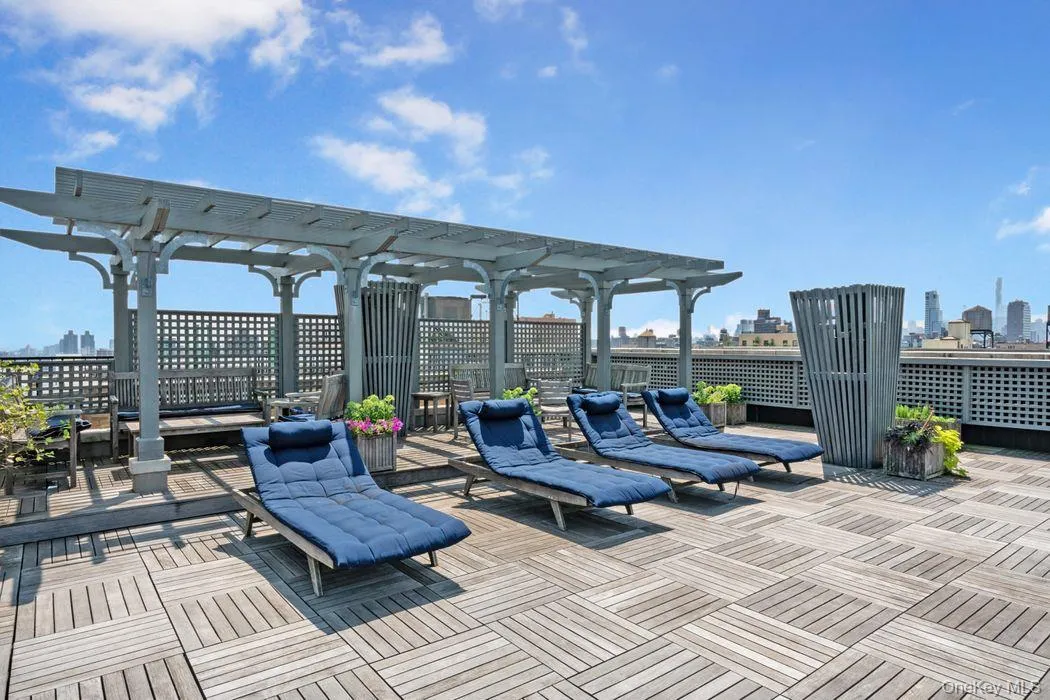 Wooden terrace featuring a pergola and a skyline view Wooden terrace featuring a pergola and a skyline view