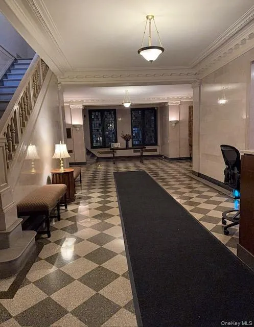 Building lobby with ornamental molding and stairway Building lobby with ornamental molding and stairway