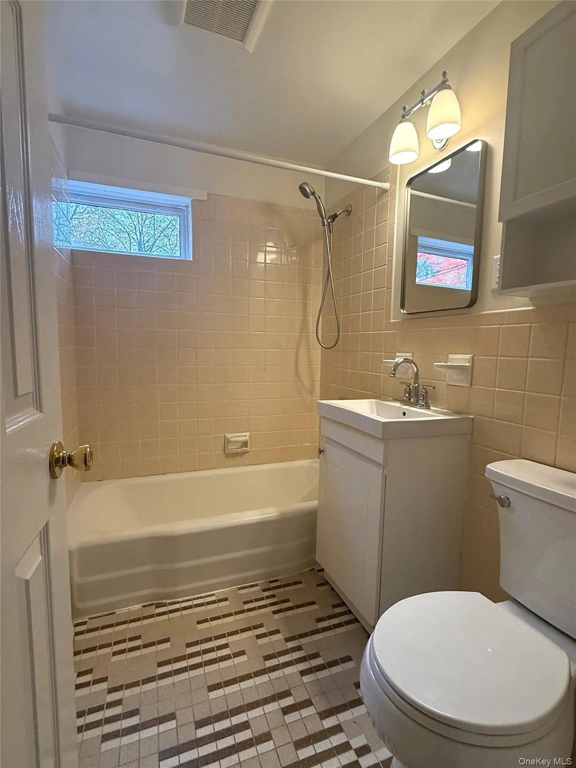 updated bathroom with tile floor, shower/soaking tub and new vanity updated bathroom with tile floor, shower/soaking tub and new vanity