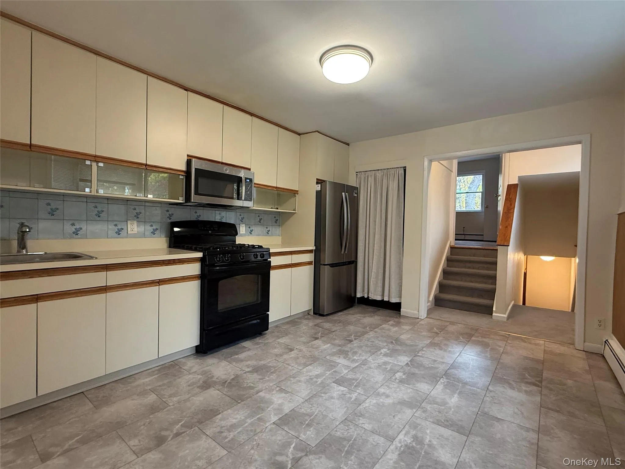 Looking from Kitchen towards upper level bedroom and stairs to lower bedroom Looking from Kitchen towards upper level bedroom and stairs to lower bedroom