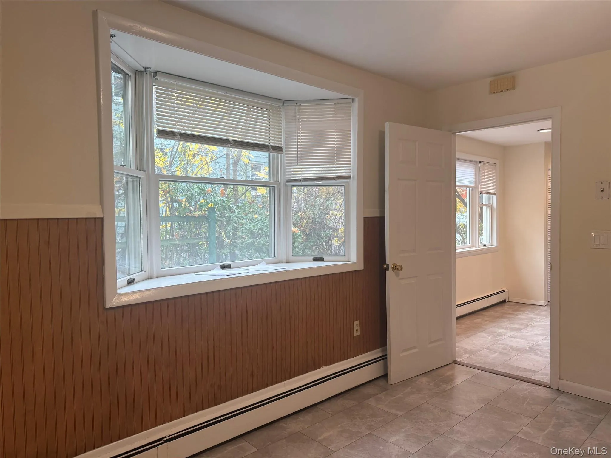 Kitchen/dining area with bay window - looking into foyer Kitchen/dining area with bay window - looking into foyer