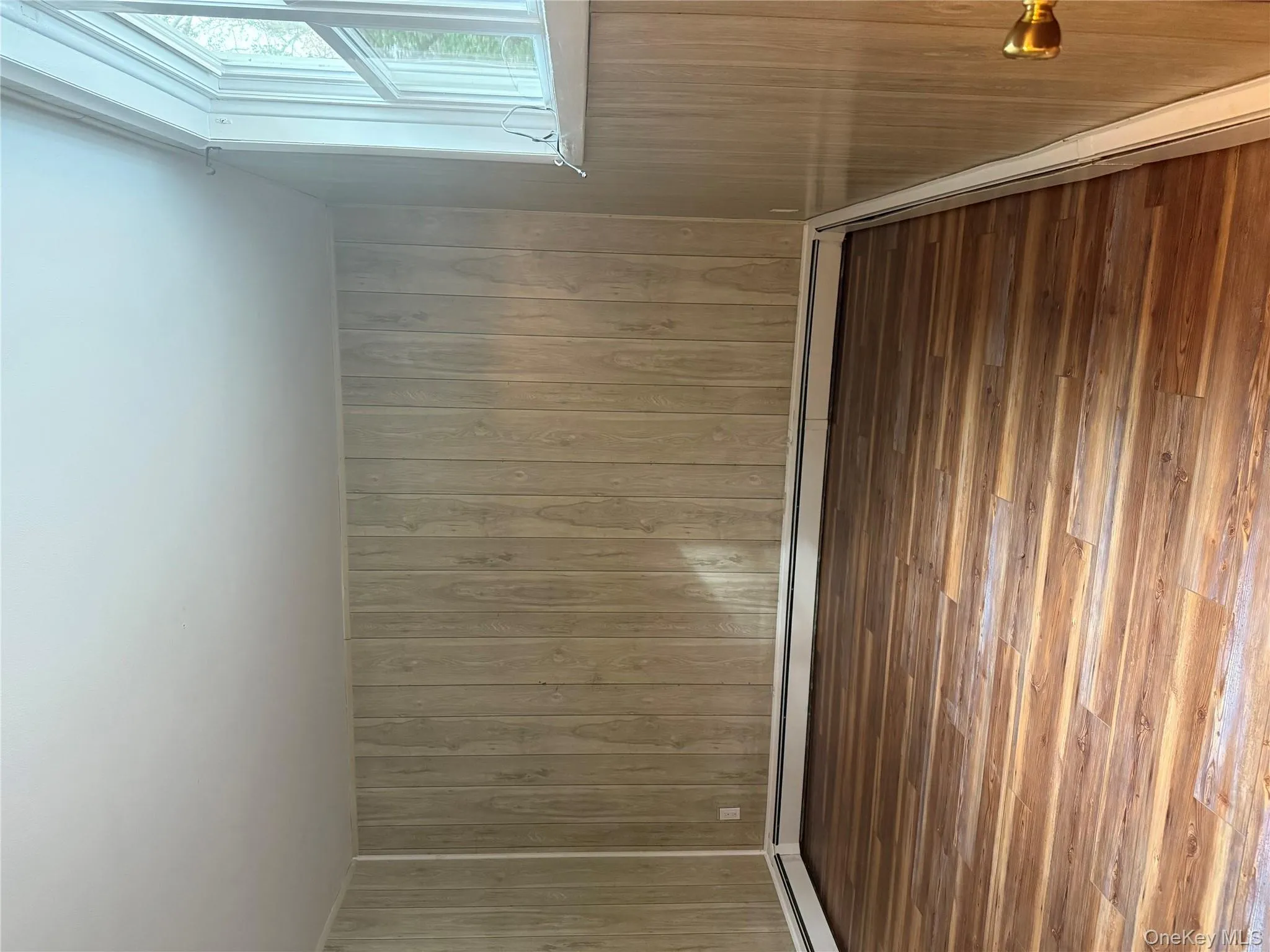 Lower level Bedroom with new wood floors and large closet Lower level Bedroom with new wood floors and large closet