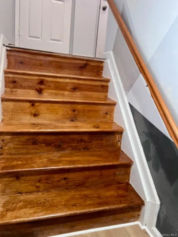 Stairs featuring wood finished floors Stairs featuring wood finished floors