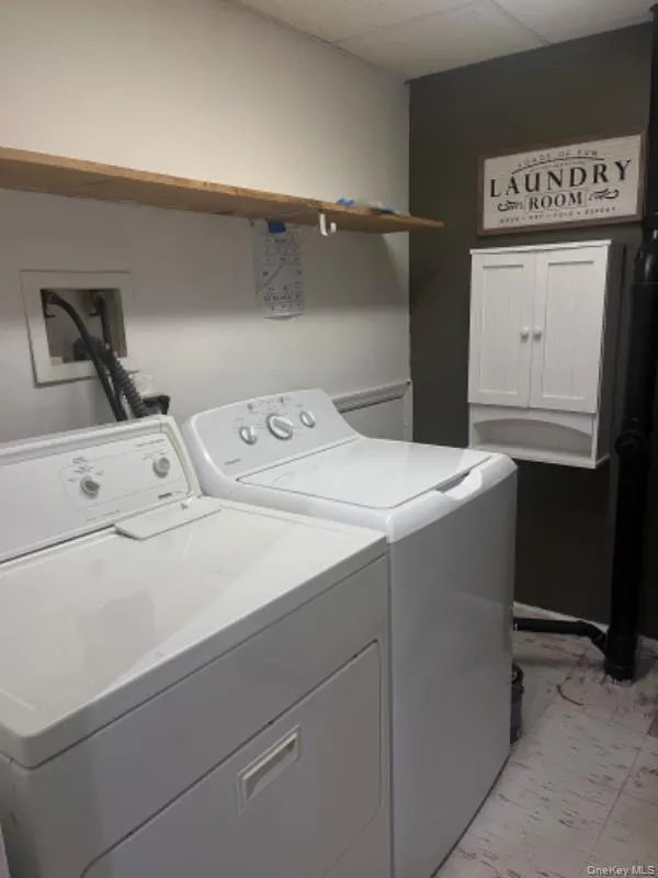 Washroom with washer and clothes dryer Washroom with washer and clothes dryer
