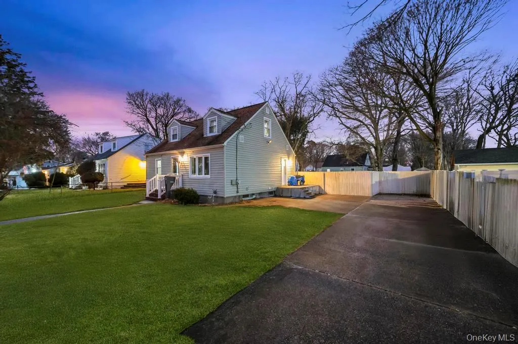 Property exterior at dusk featuring concrete driveway Property exterior at dusk featuring concrete driveway