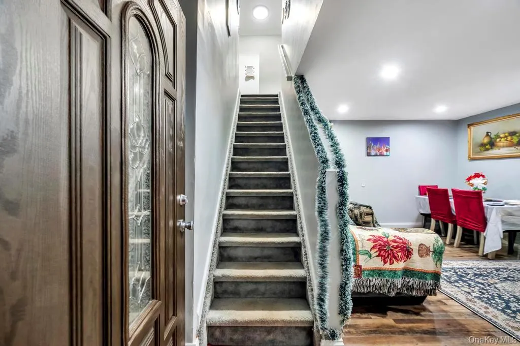 Stairway with wood finished floors and recessed lighting Stairway with wood finished floors and recessed lighting
