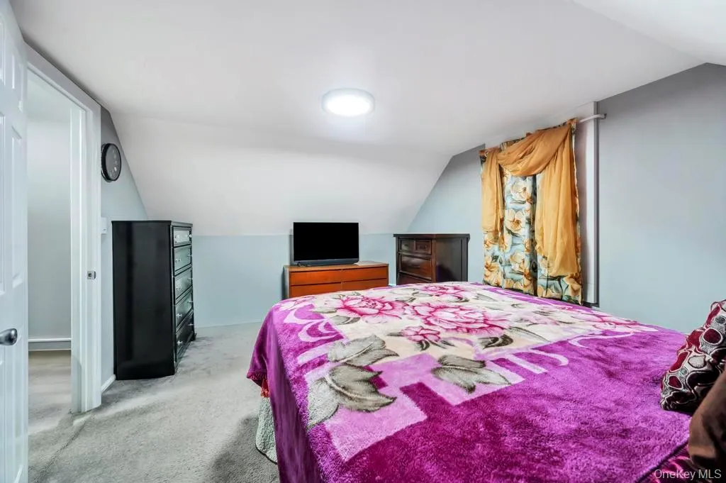 Carpeted bedroom with lofted ceiling Carpeted bedroom with lofted ceiling