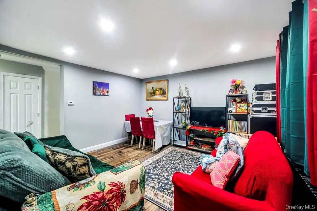 Living area featuring wood finished floors and recessed lighting Living area featuring wood finished floors and recessed lighting