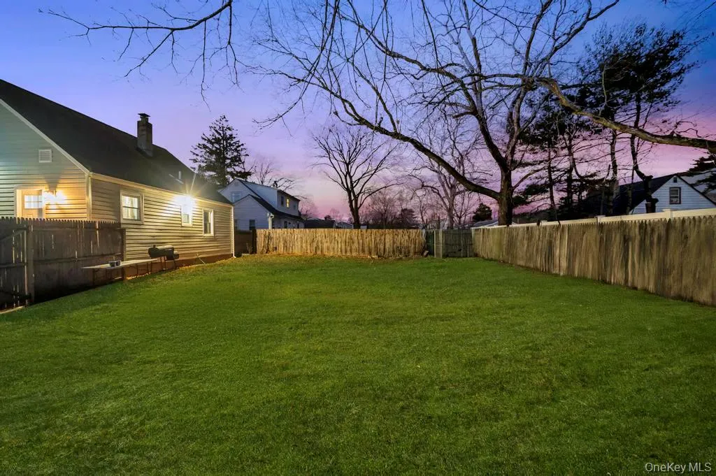 Yard at dusk featuring a fenced backyard Yard at dusk featuring a fenced backyard