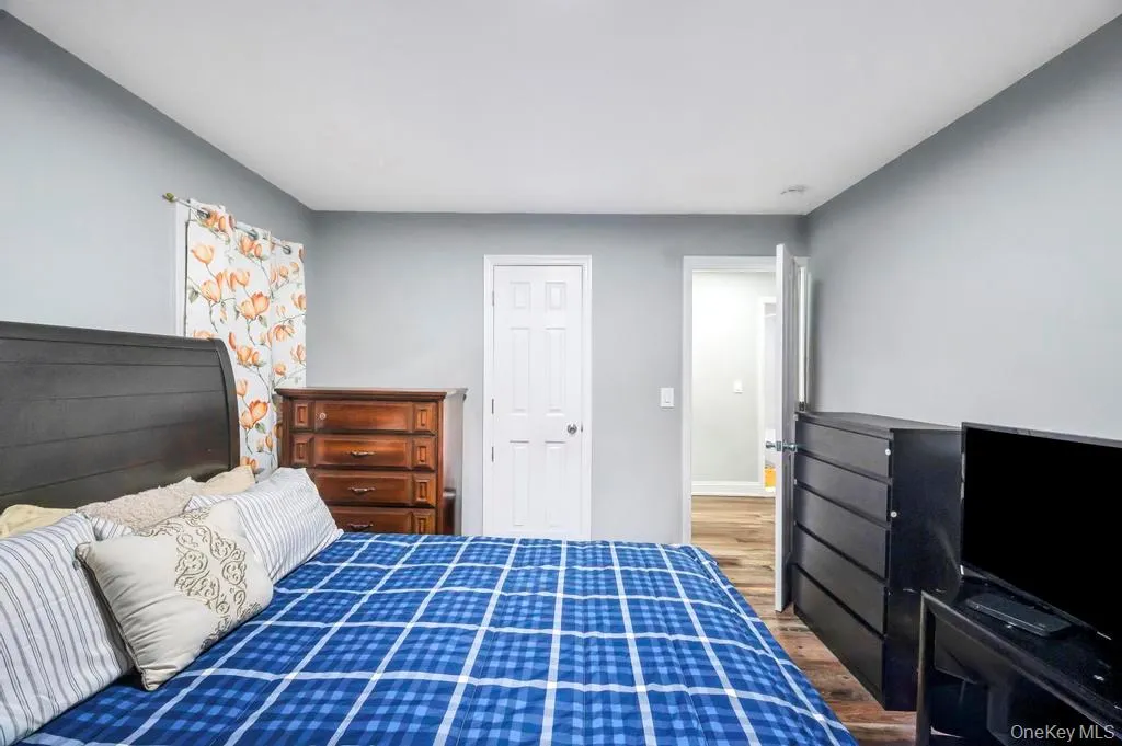 Bedroom with wood finished floors and baseboards Bedroom with wood finished floors and baseboards