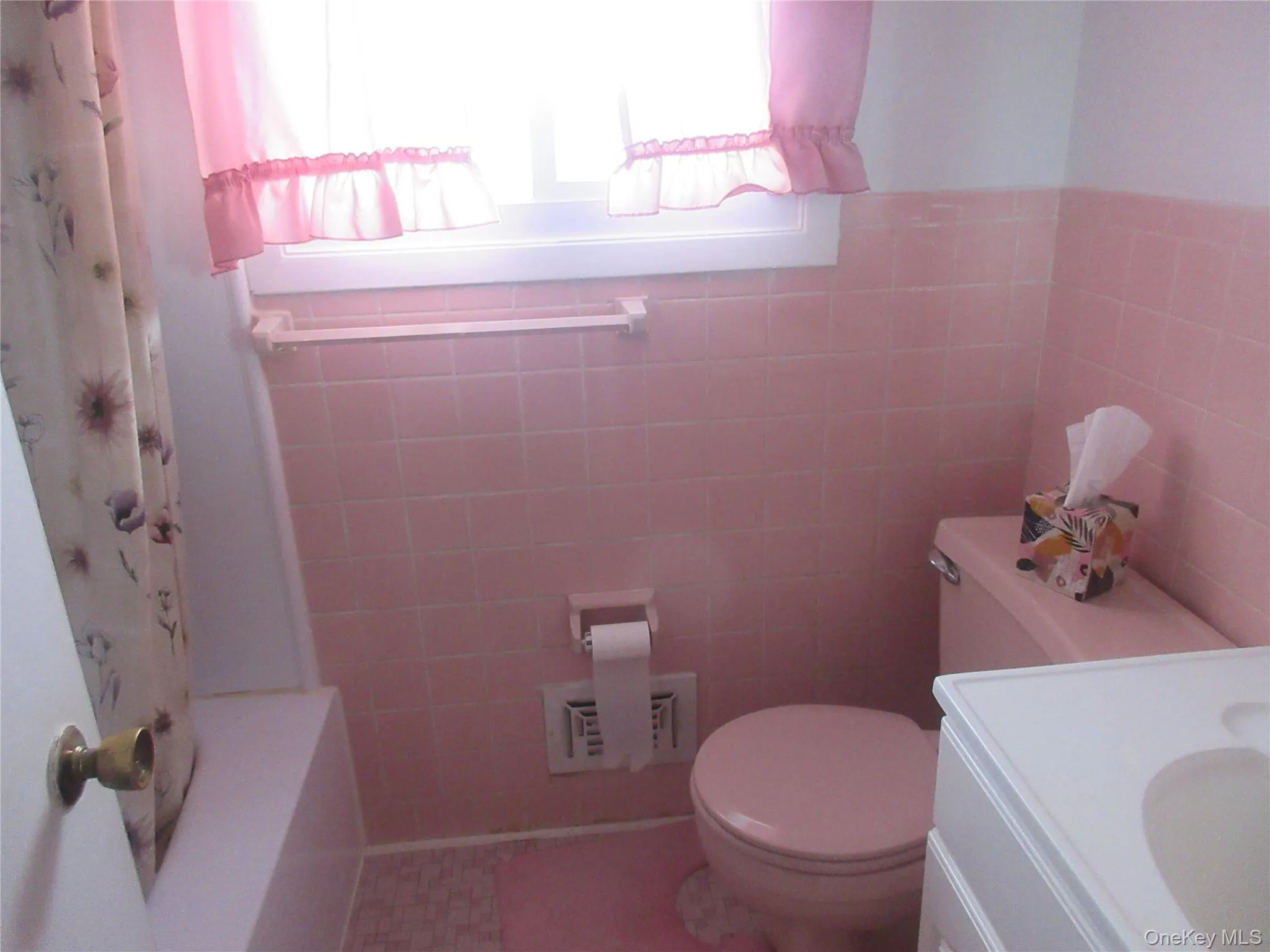 Full bathroom featuring vanity, tile walls, and a wainscoted wall Full bathroom featuring vanity, tile walls, and a wainscoted wall