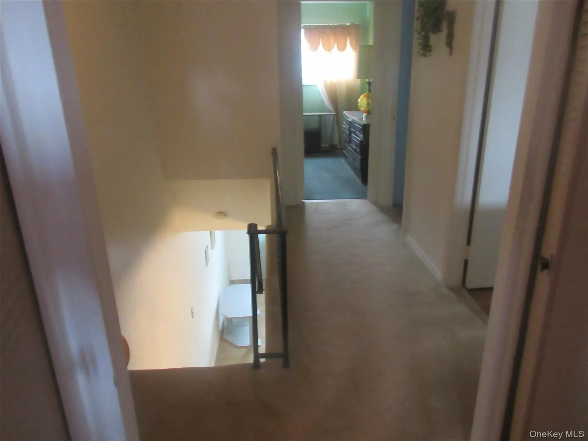 Hall featuring carpet flooring and baseboards Hall featuring carpet flooring and baseboards