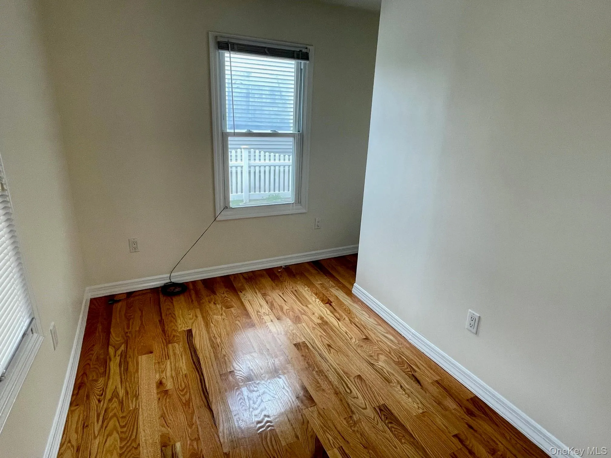 Unfurnished room featuring baseboards and light wood finished floors Unfurnished room featuring baseboards and light wood finished floors