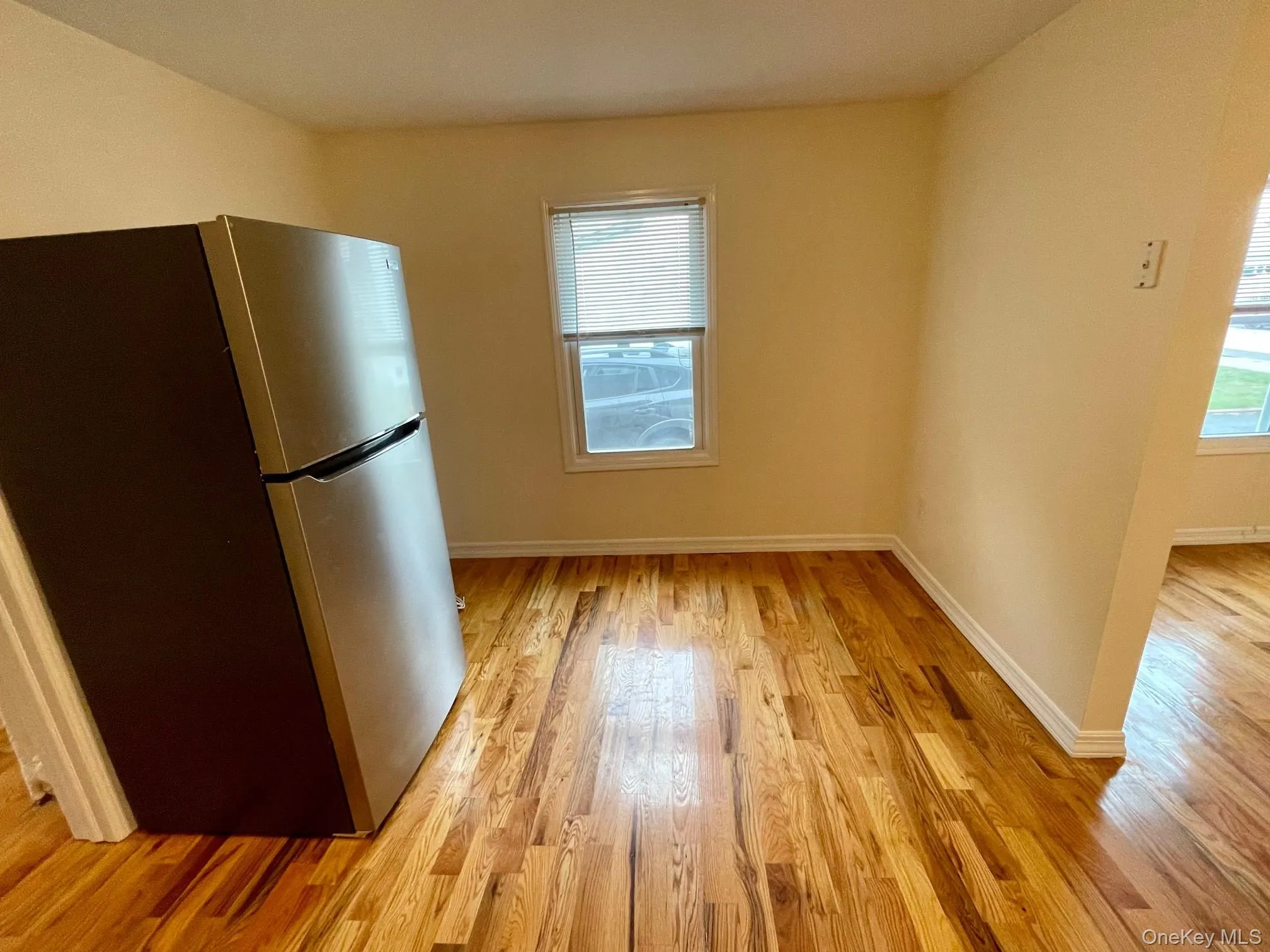 Kitchen with freestanding refrigerator and light wood-type flooring Kitchen with freestanding refrigerator and light wood-type flooring