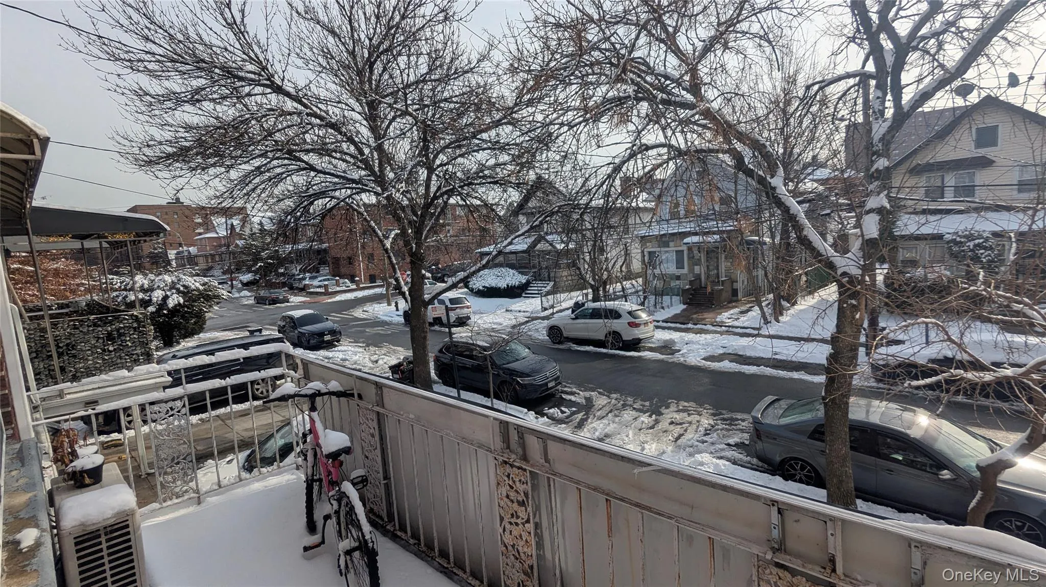 Snow covered back of property with a residential view Snow covered back of property with a residential view