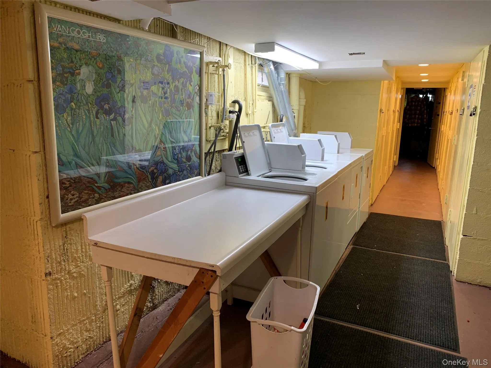 Community laundry with concrete block wall and washing machine and clothes dryer Community laundry with concrete block wall and washing machine and clothes dryer
