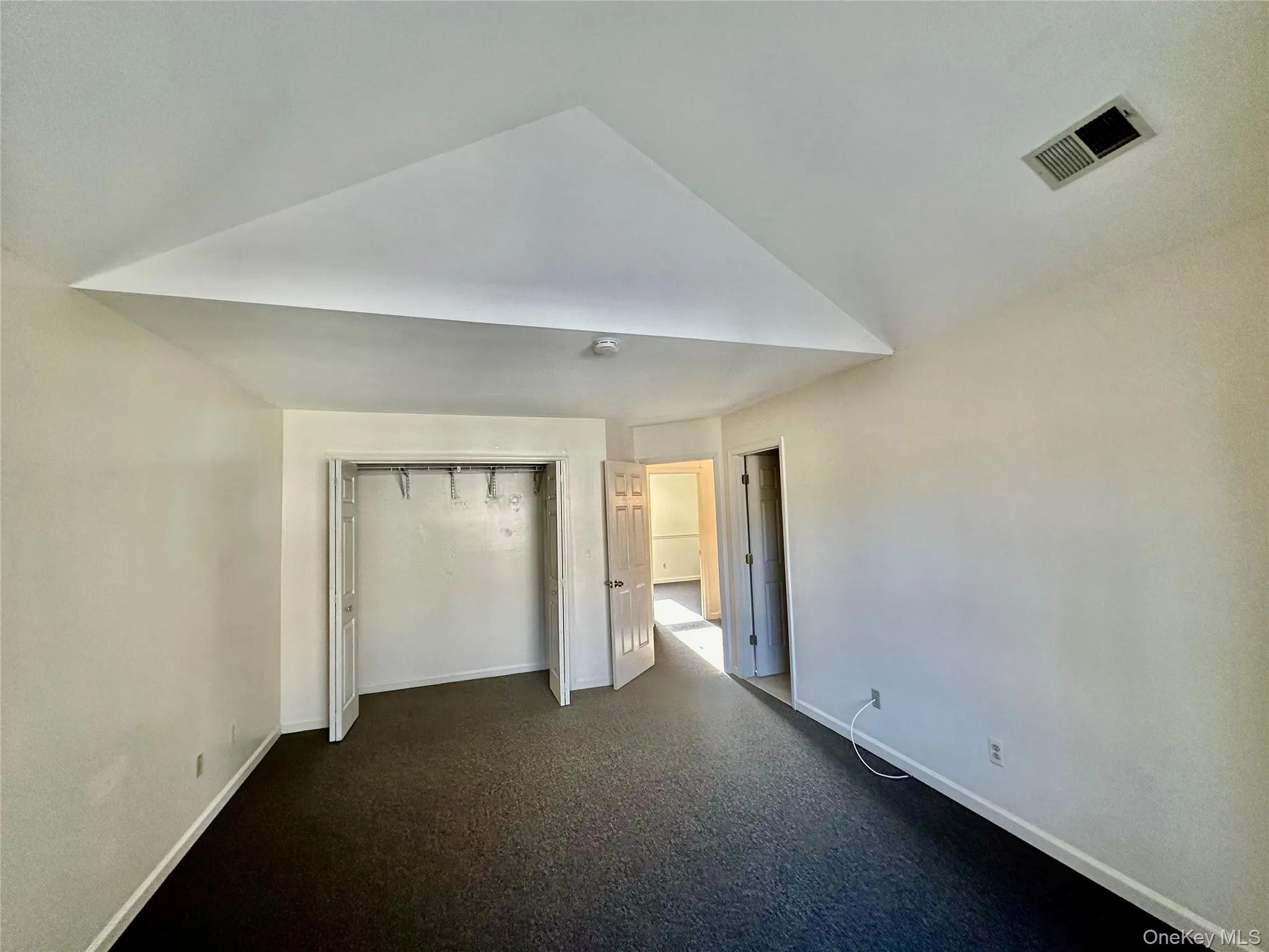 Primary bedroom with vaulted ceiling Primary bedroom with vaulted ceiling