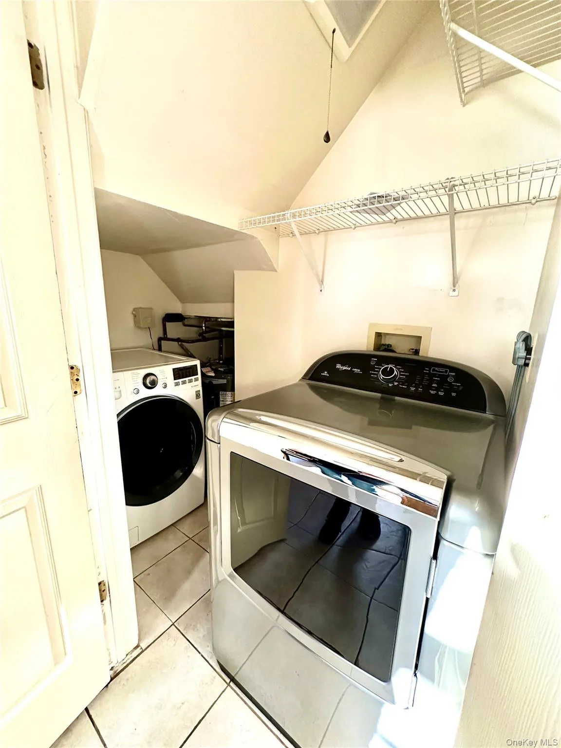 Laundry off the kitchen with washer dryer and water heater Laundry off the kitchen with washer dryer and water heater