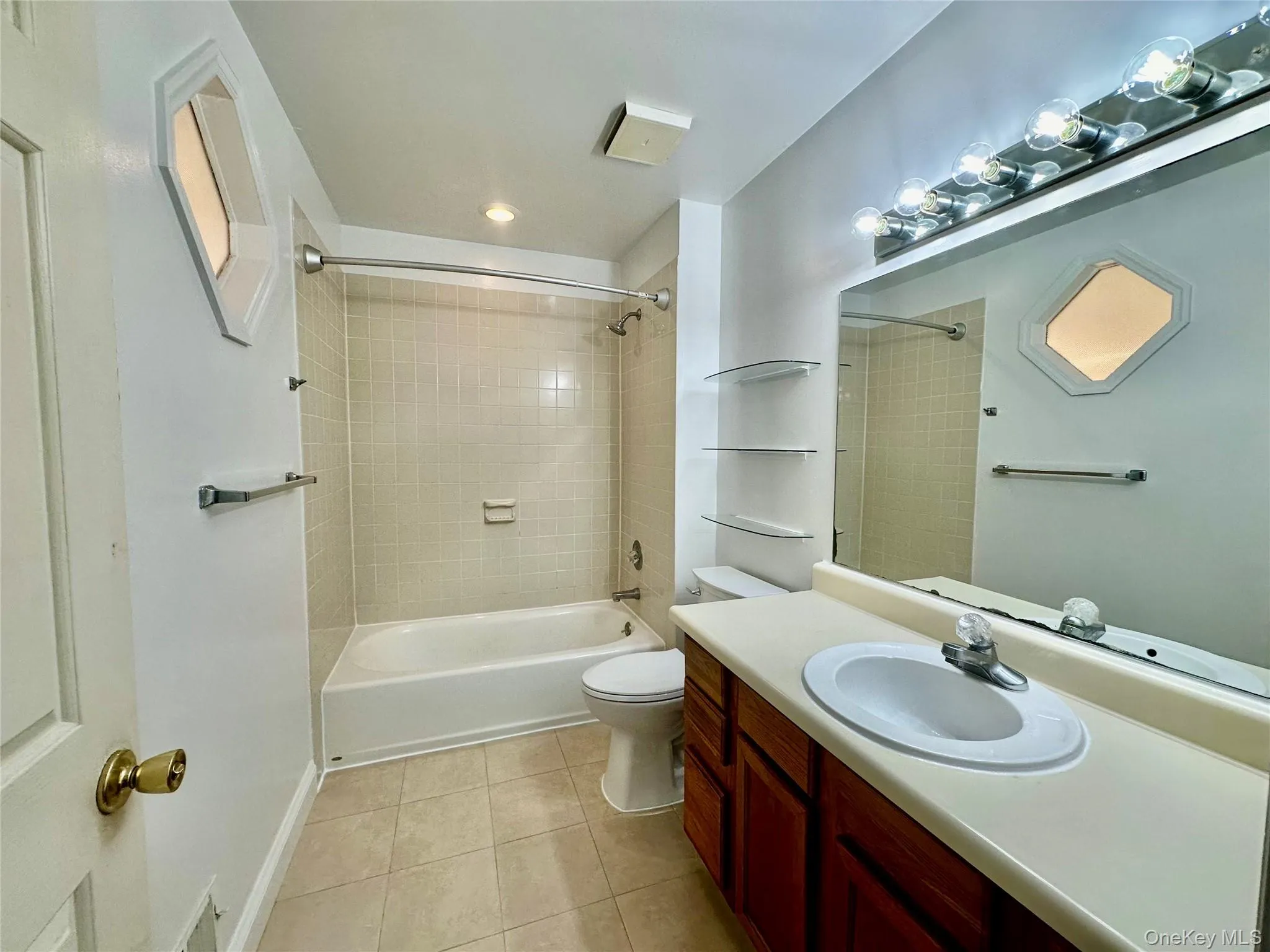 Full bathroom upstairs with entrance to the primary bedroom and the hall Full bathroom upstairs with entrance to the primary bedroom and the hall